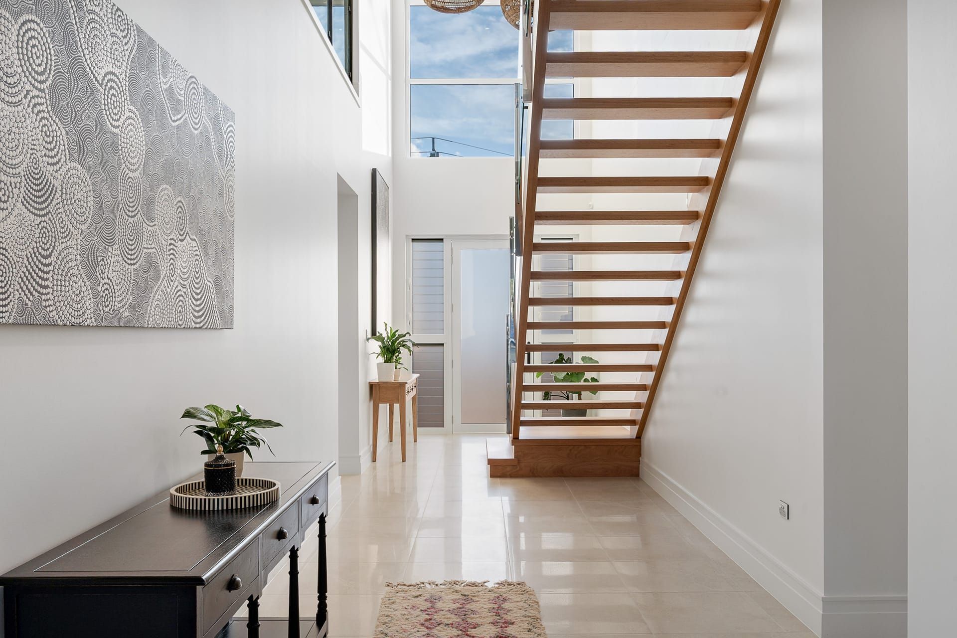 Entry hallway with open-tread timber staircase