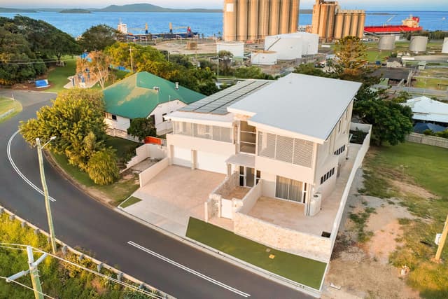 Aerial rear view of home with harbour backdrop