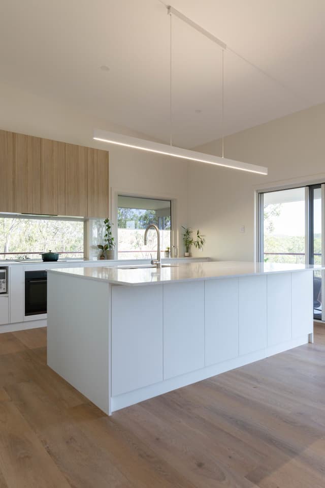 Kitchen island with linear pendant lighting