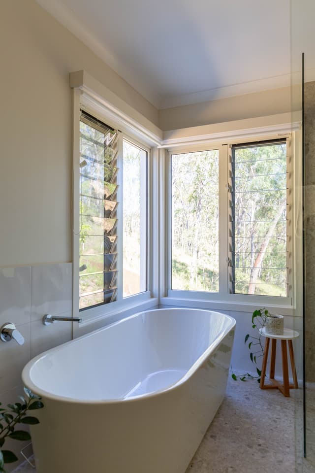 Freestanding bath with bush views through windows
